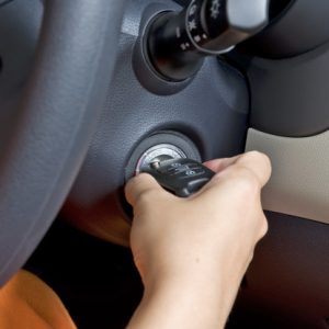Woman hand hold car key ready to start engine